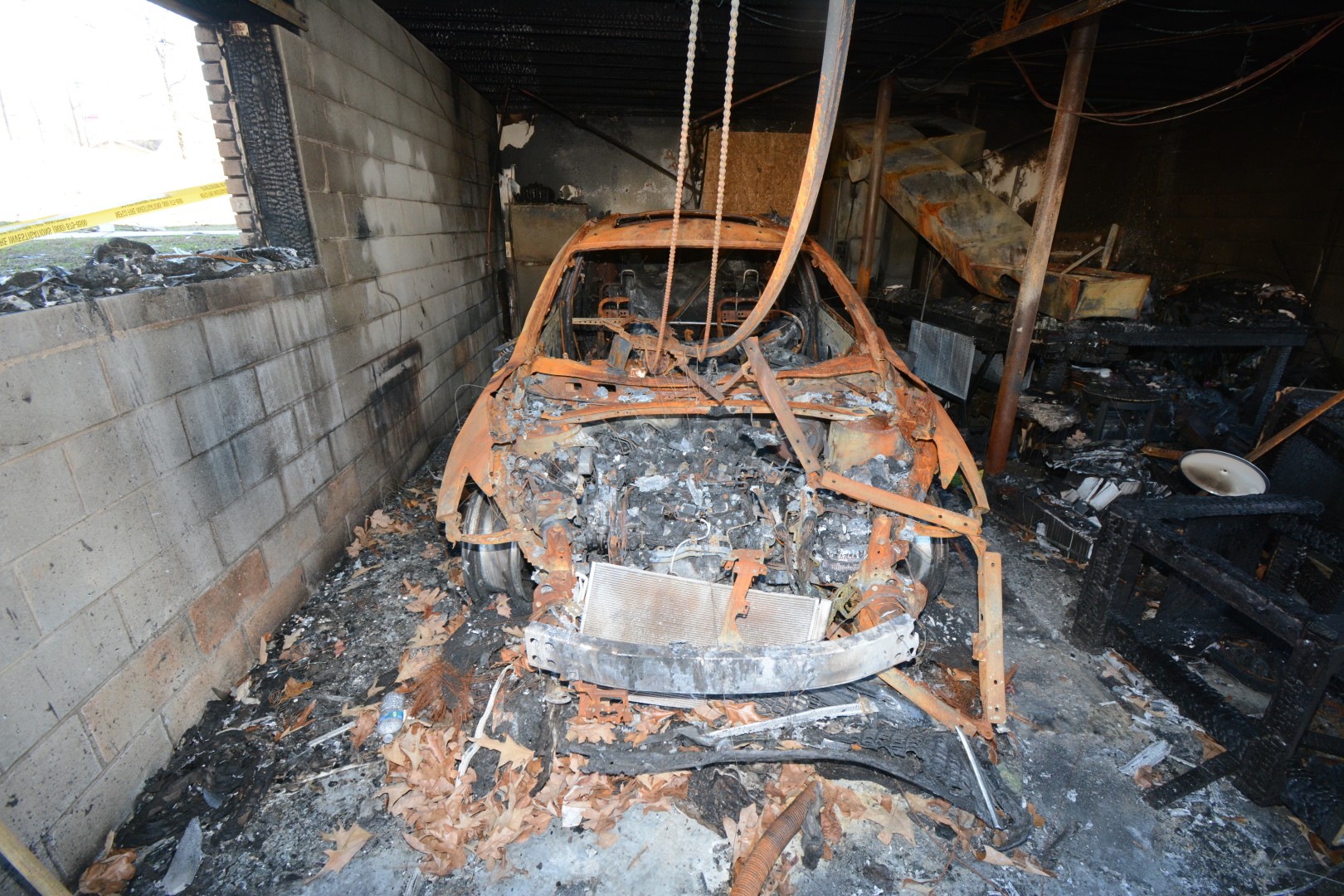 Burned vehicle in a garage